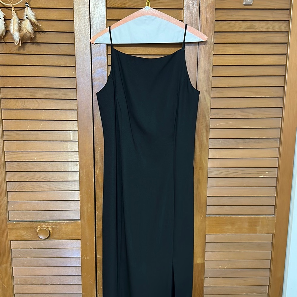 Black dress with slit and dropping back.